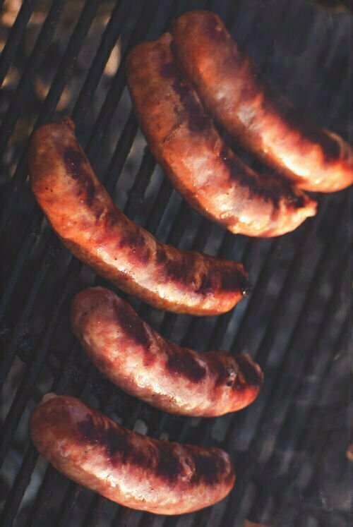 Morcilla sausages cook on a bbq grill