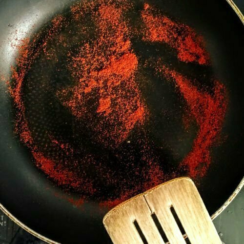 toasted sweet paprika in a frying pan 
