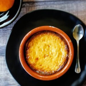 An earthenware dish of Baked cheesecake with honey and orange