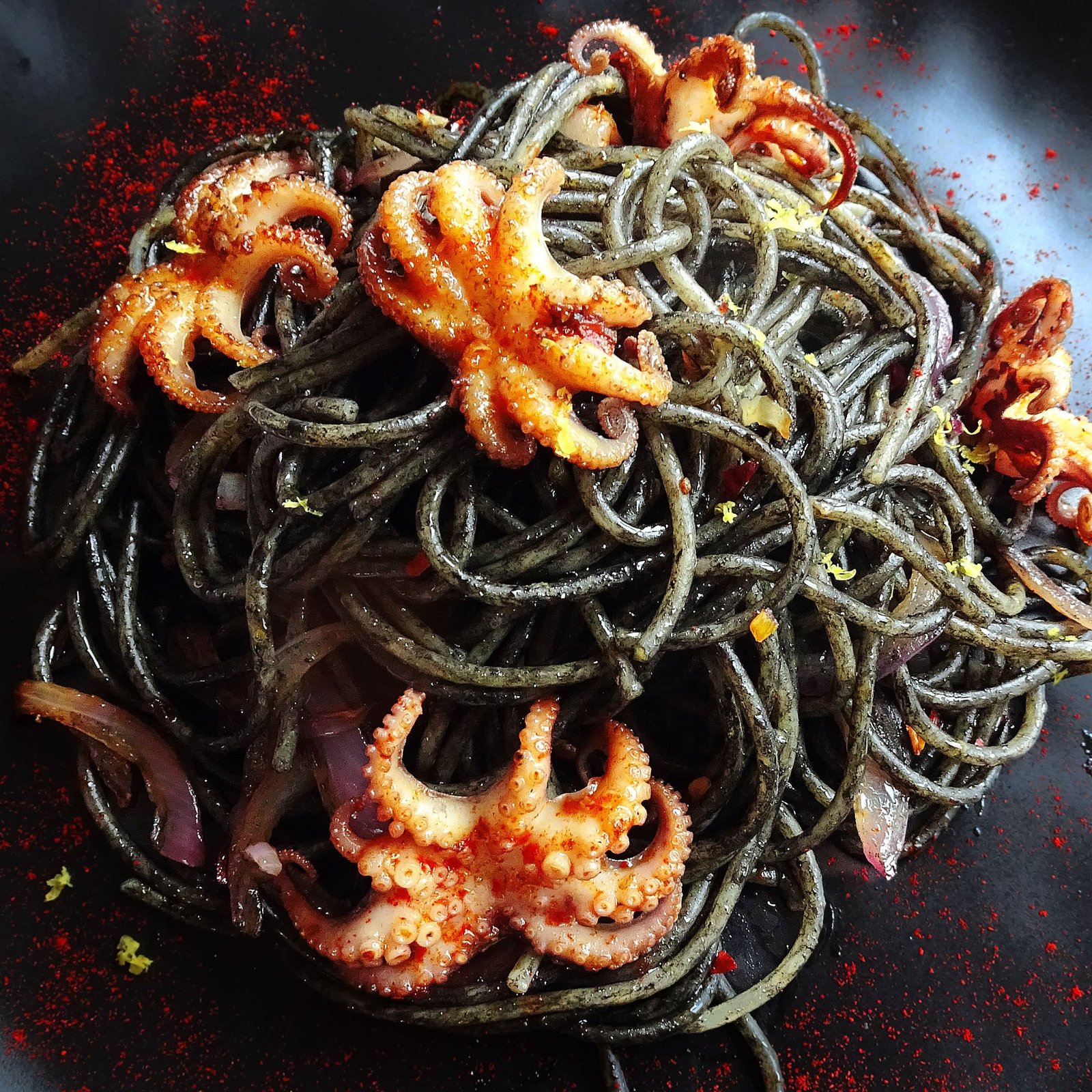 Close up shot of squid ink spaghetti with baby squid