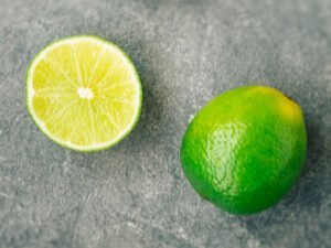two limes sit on a grey bacckground
