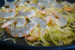 shrimp, galric, and onions in a frying pan