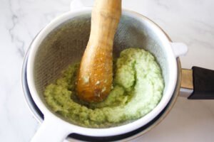 pulp leftover from cucumber soup is run through a fine sieve