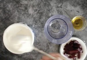 ingredients for beetroot and yogurt drizzle are being added to a food processor