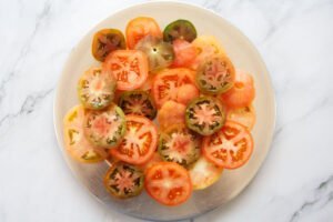 Slices of tomato sit on a serving platter
