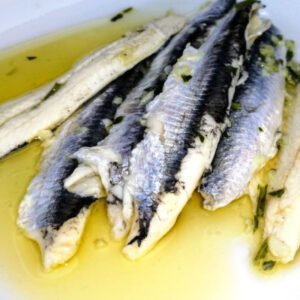 A plate of boquerones, spanish anchovies marinaded in vinegar, garlic, and parsley, and drizzled with extra virgin olive oil