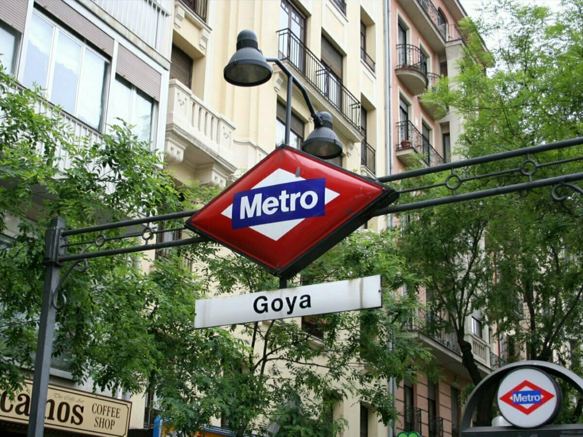 The Goya Metro sign in front of a leafy green street