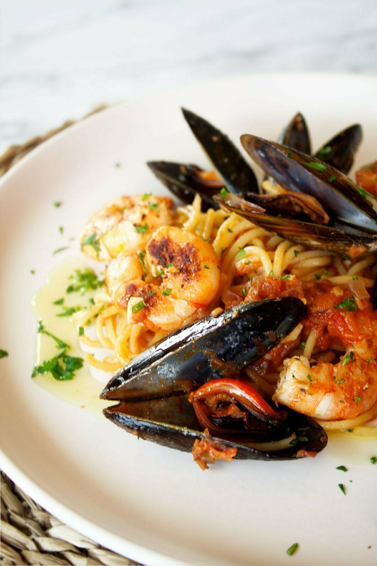 a plate of shrimp and mussels pasta