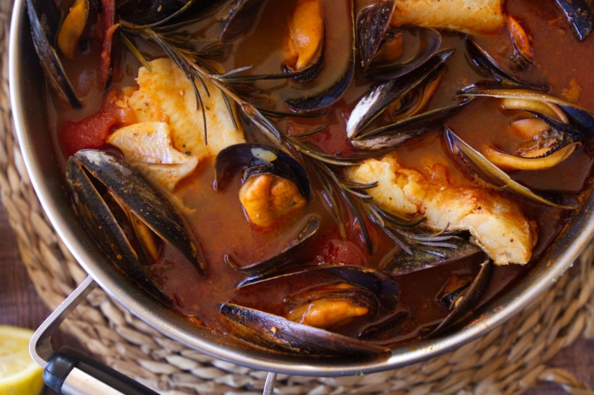 Mussels and chunks of fish float in a broth made with Mediterranean fish stew