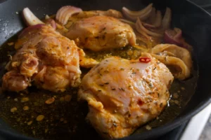 marinated chicken cooks in a skillet