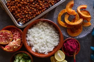 Ingredients for making a Mediterranean rice bowl are laid out on a counter.