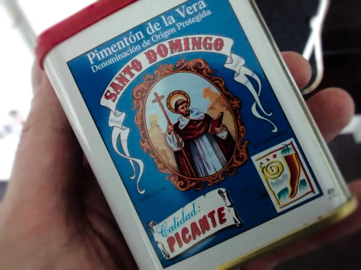 a hand holds a small tin of Pimienton de la Vera Paprika