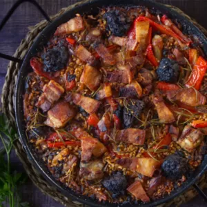 a large pan of arroz al horno sits waiting to be served