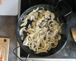 some diced onion cooks in a pan