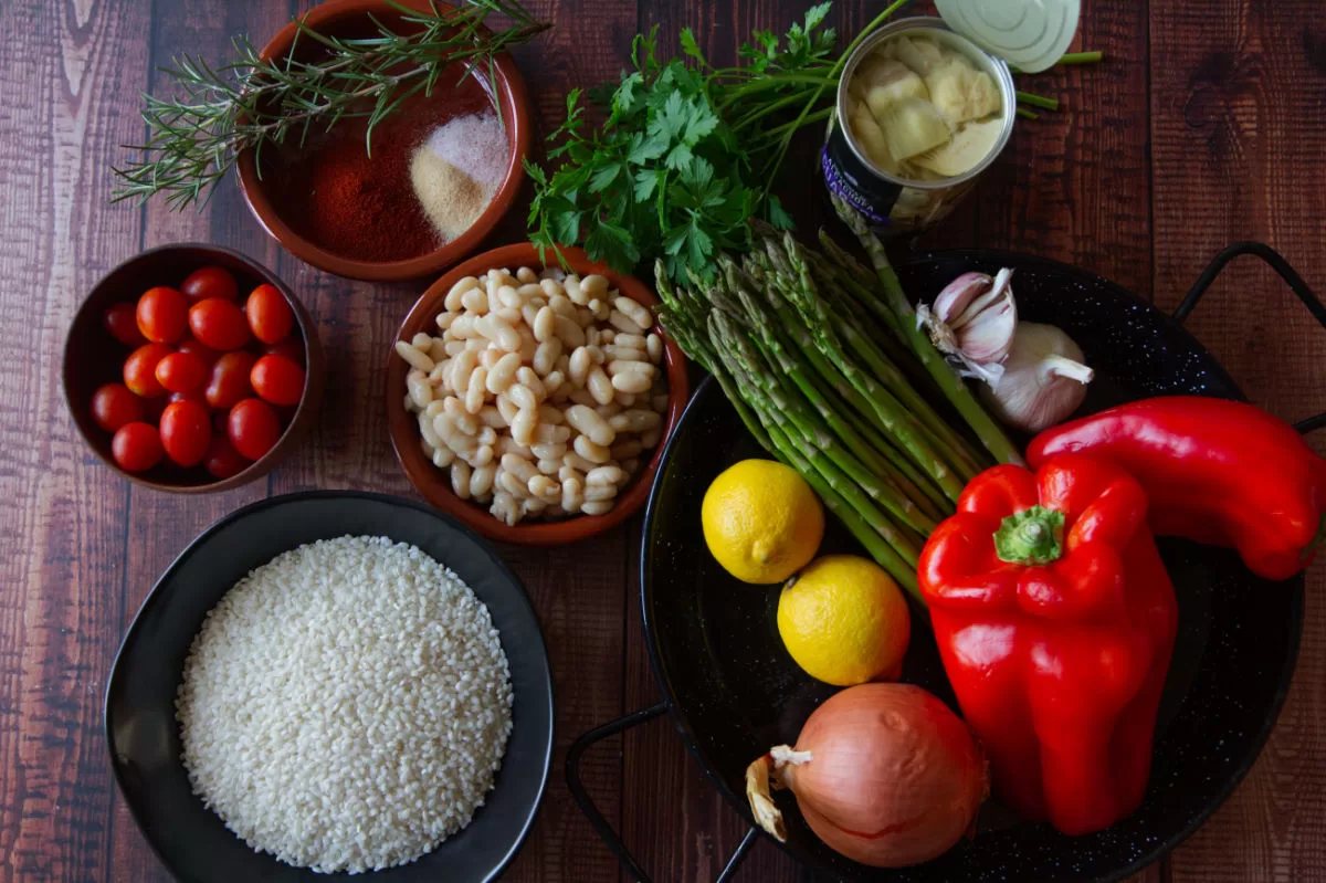 ingredients for making vegan oven-bbaked rice are laid out on a wooden table