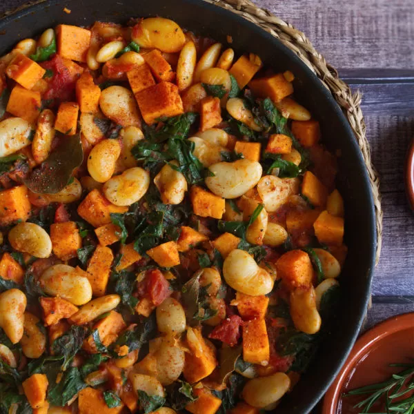 a large pot of smoky butter bean stew with sweet potato and kale