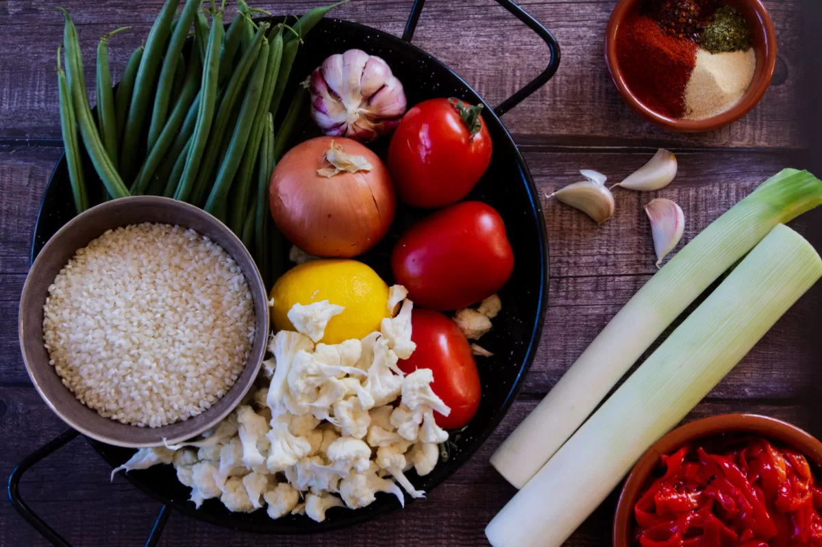 ingredients for making Spanish oven-baked rice are laid out on a countertop