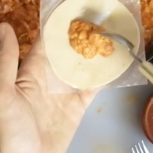 filling is added to the middle of an empanada disk.