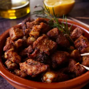 A small tapas serving of paprika-infused pork bites