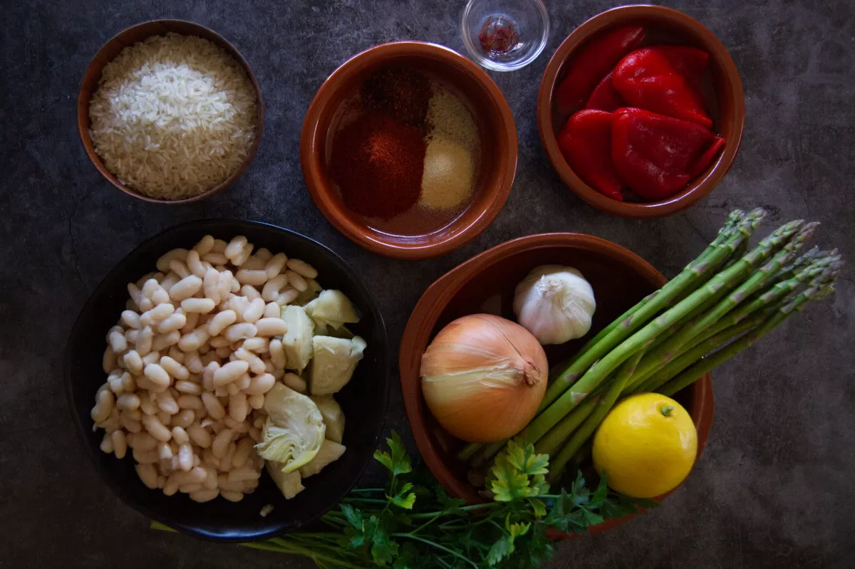 Ingredients for making Spanish oven-baked rice sit on a kitchen counter.