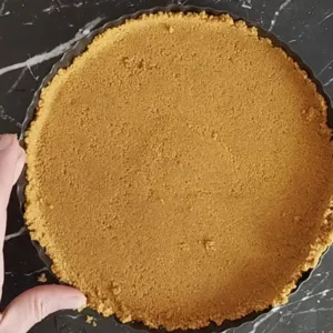 a smooth cheesecake base ready to be refrigerated.