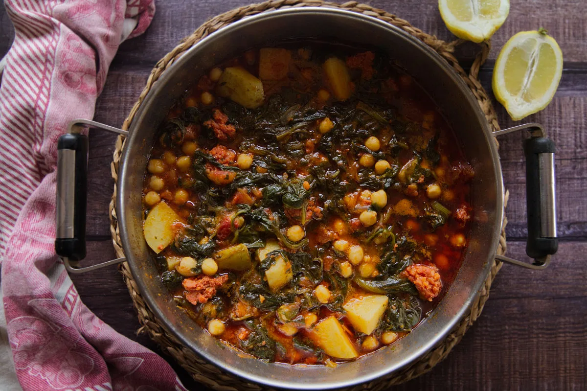 A large pot of Smoky chorizo stew with spinach and chickpeas.