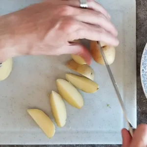 Small potatoes are cut into wedges.