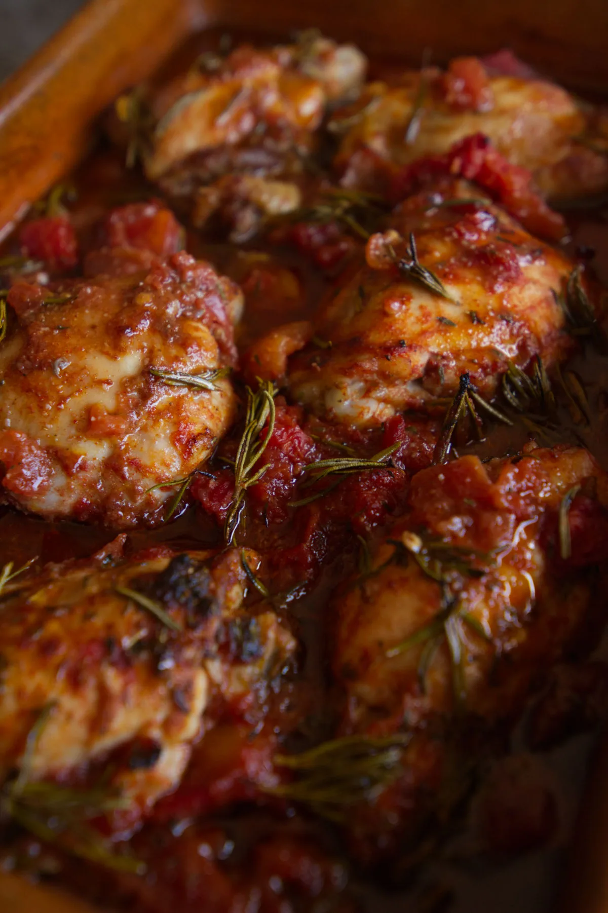 Roast chicken thighs cooked in a red wine, tomato, and herb sauce.