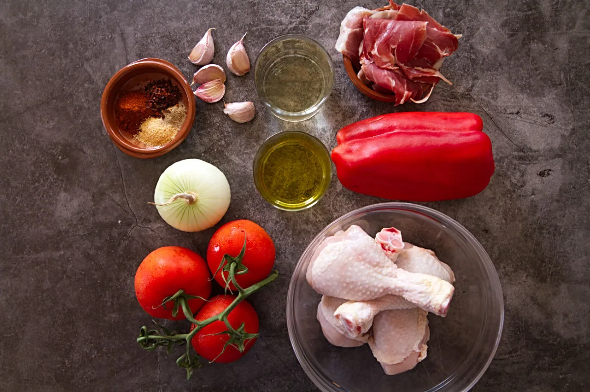 ingredients used to make Spanish chicken chilindron are laid out on a kitchen counter. 