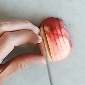 A peach being sliced
