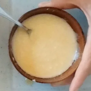 A yogurt, honey, and olive oil dressing in a small bowl.