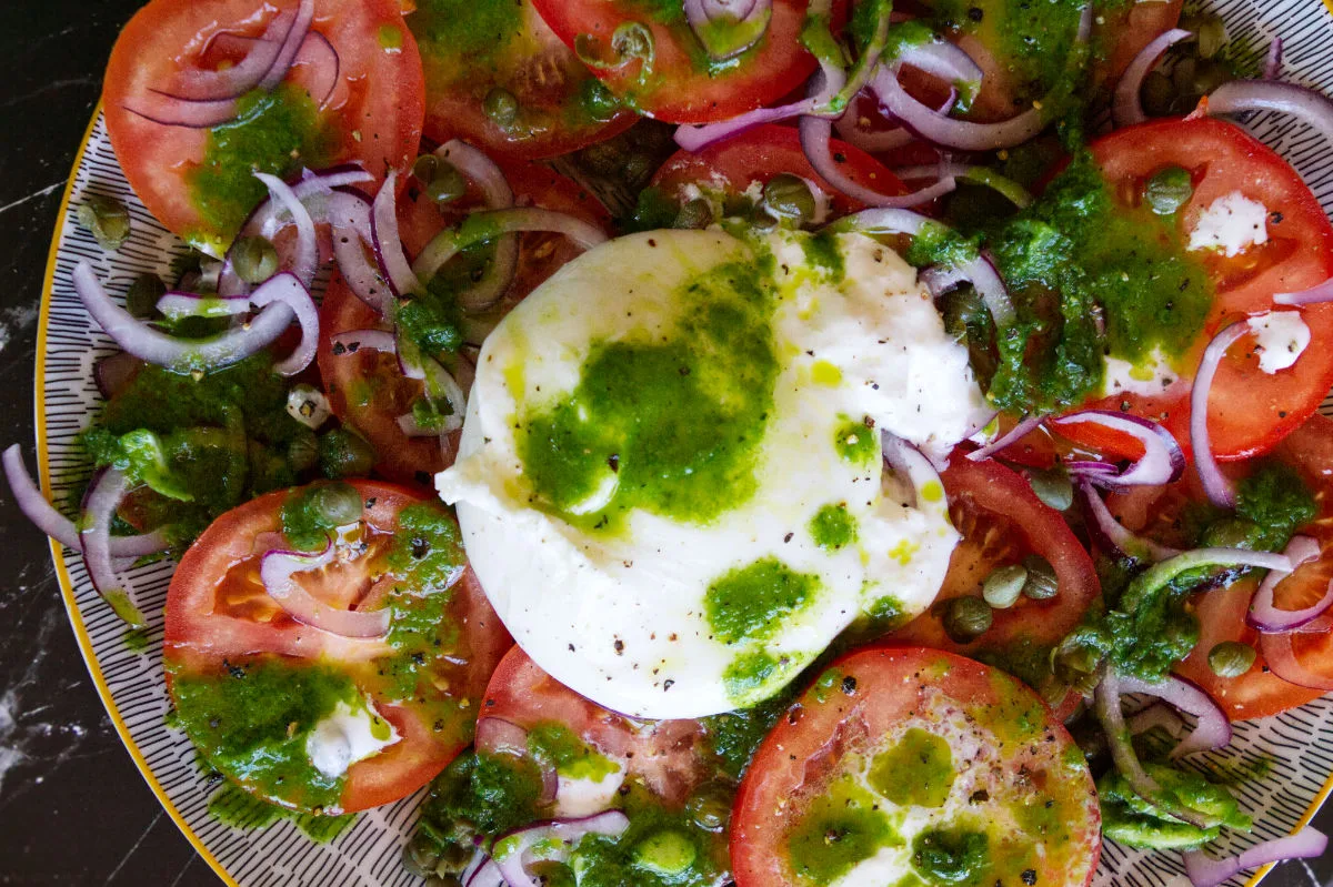 A plate of tomato burrata salad