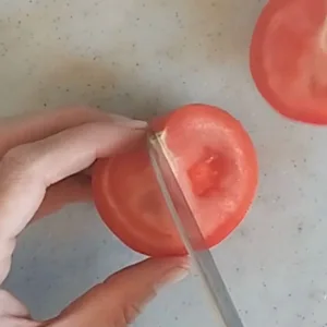 A tomato chopped in half.