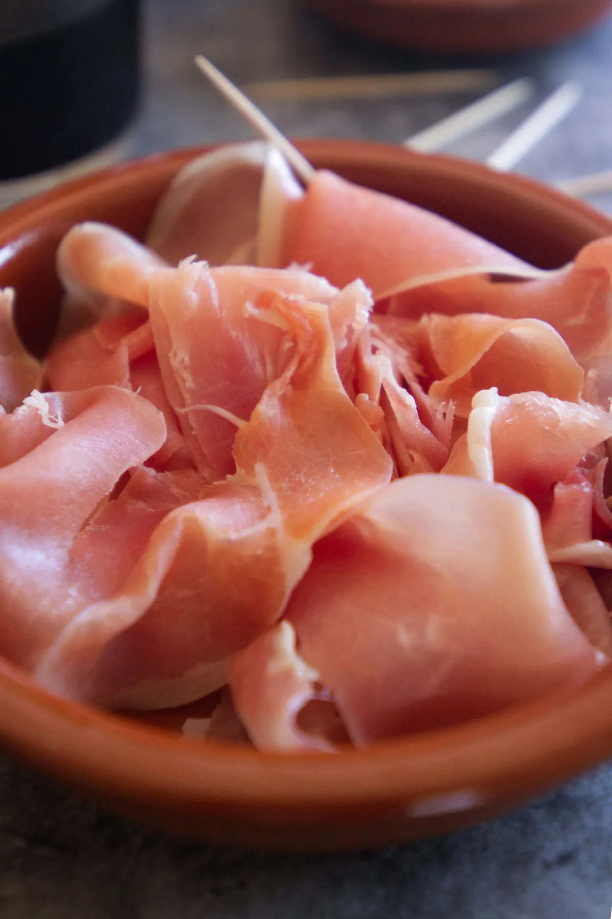 A small bowl of serrano ham is served as a tapas.