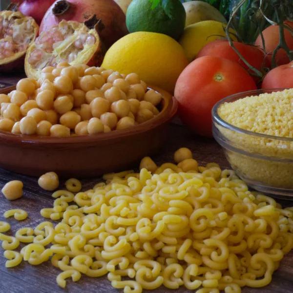 pasta, legumes, rice, and other grains sit beside fresh fruit and vegetables.