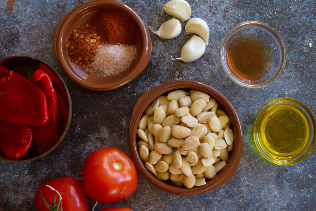 Romesco sauce ingredients sit on a kitchen counter. 