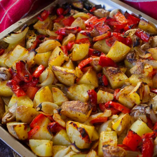 A large baking sheet loaded with cooked Poor Man's potatoes.