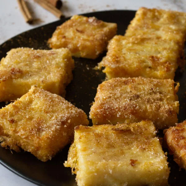 A plate of Leche frita, fried milk squares