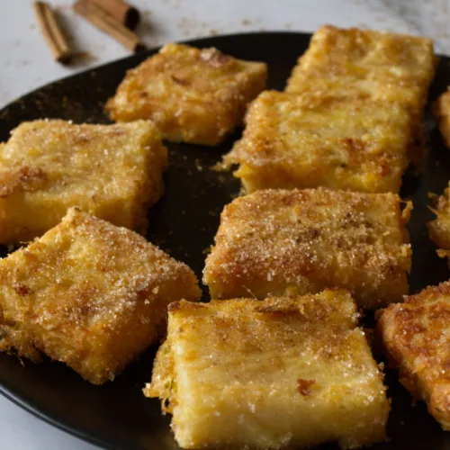 A plate of Leche frita, fried milk squares