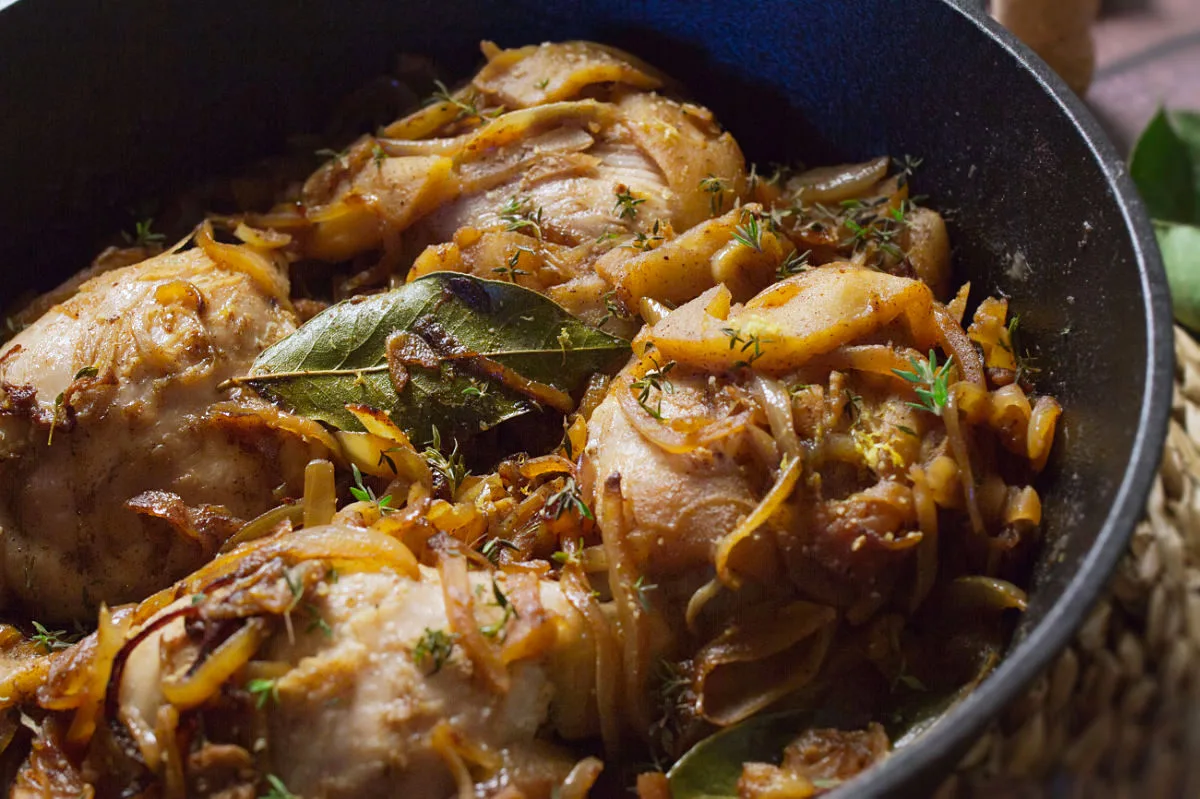 A large pot of one pot chicken thighs in cava and caramelized apples.