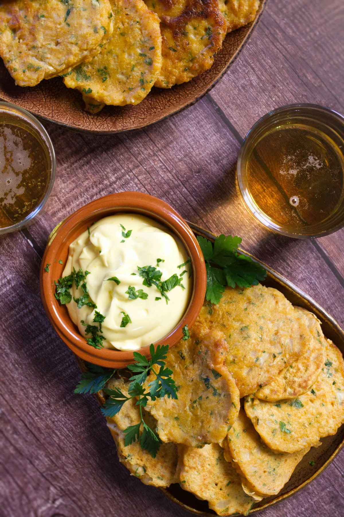 A tapas serving of Spanish cod fritters sits beside some homemade aioli.