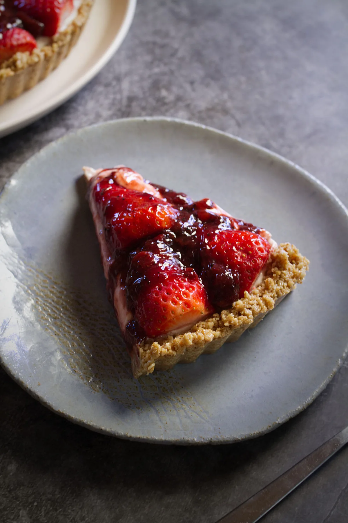 A slice of a no-bake strawberry cheesecake.