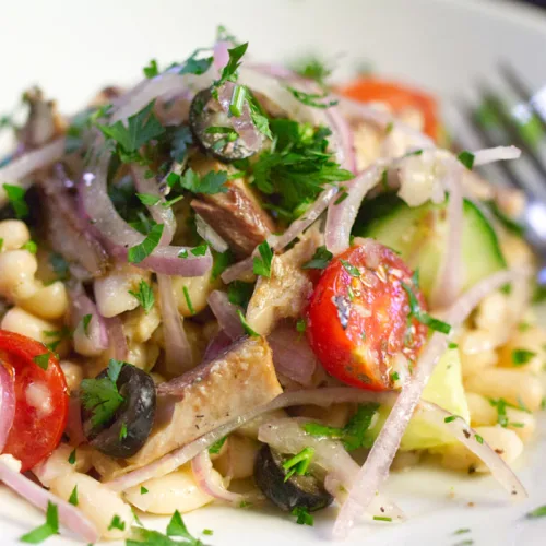 A bowl of white bean salad with sardines